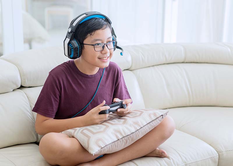 Child playing video games with headset