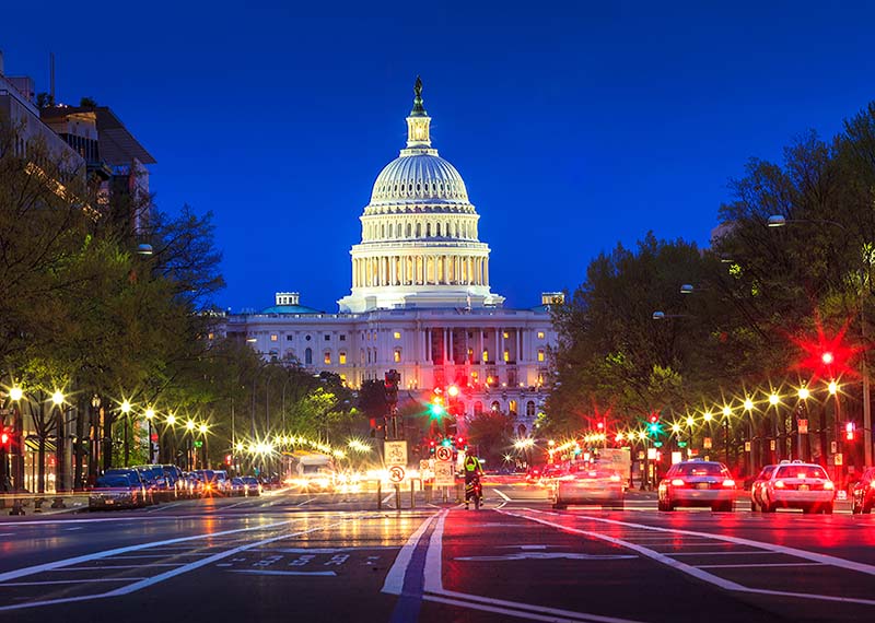 Washington DC capital at dusk with cars and street lights in foreground