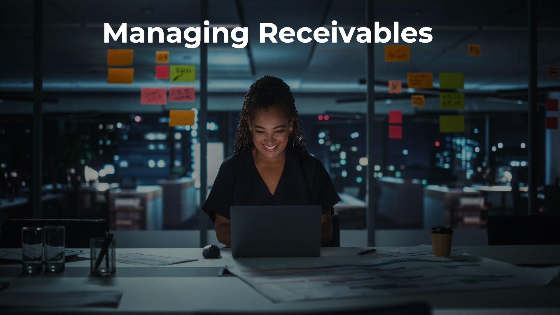 woman in front of laptop with cityscape in background