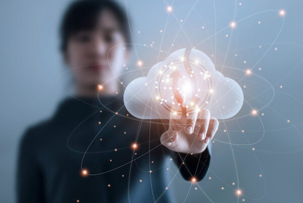 woman with black turtleneck shirt touching image of cloud with network of connections