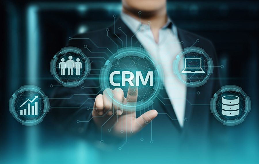 business man in dark suit with finger touching a symbol for CRM