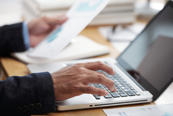 saas finance professional reviewing an invoice on laptop