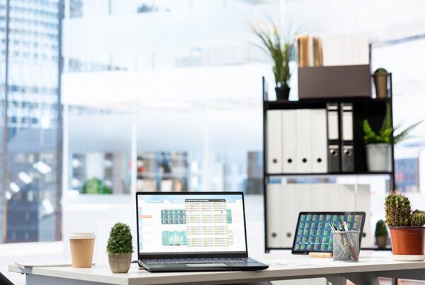 modern office with laptop on desk and buildings in the background