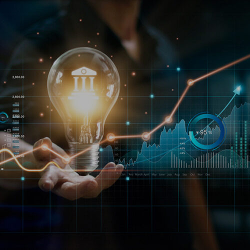 business man holding light bulb with saas finance and accounting charts in the foreground