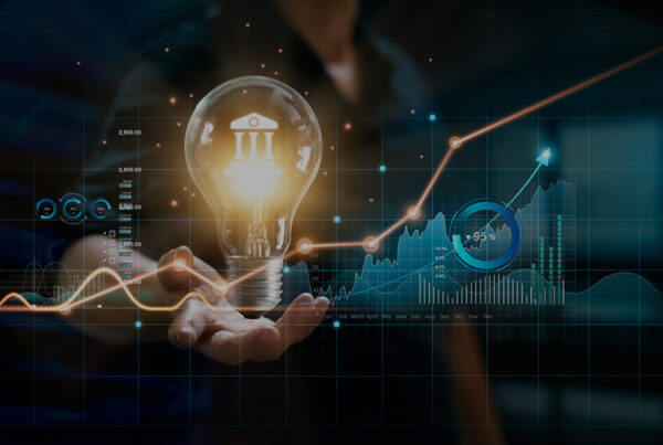 business man holding light bulb with saas finance and accounting charts in the foreground