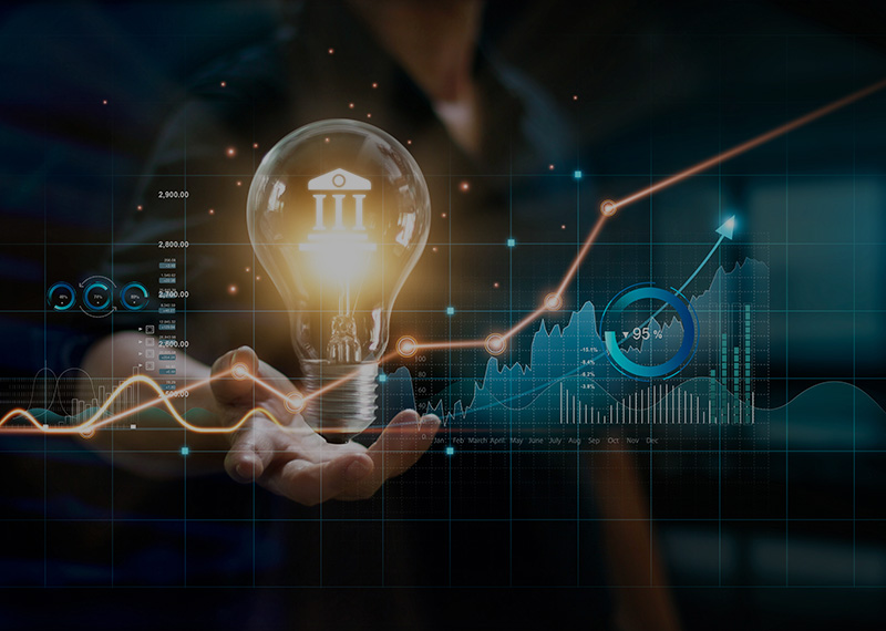 business man holding light bulb with saas finance and accounting charts in the foreground