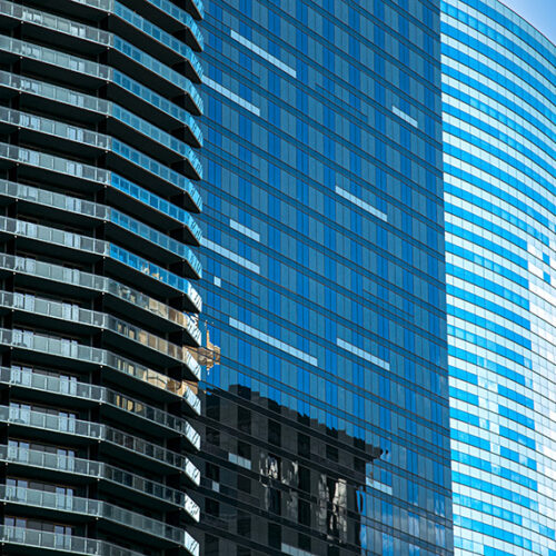 three office buildings with glass exteriors and reflections