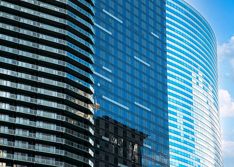 three office buildings with glass exteriors and reflections