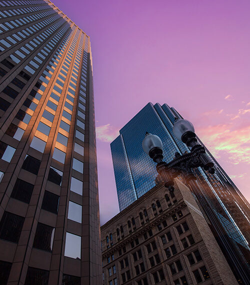Boston downtown morning of AFP conference 2025 with purple sky and sun rising on horizon