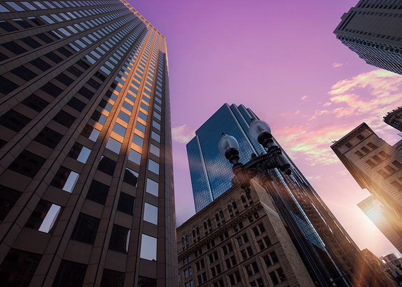 Boston downtown morning of AFP conference 2025 with purple sky and sun rising on horizon