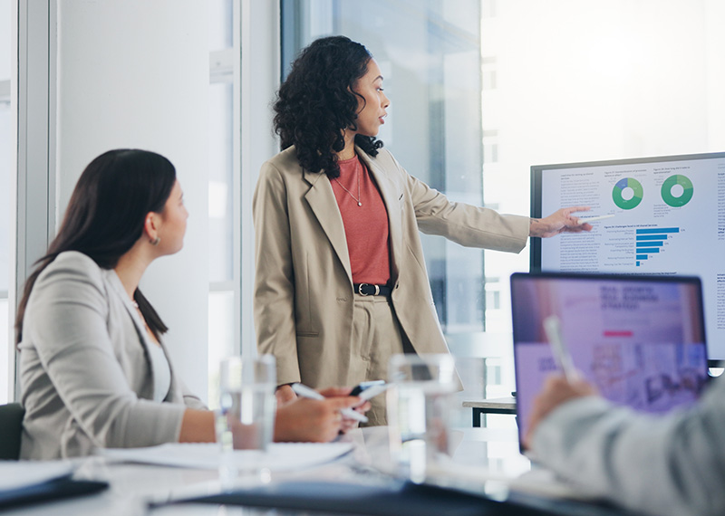 Go-to-market team discussing quote-to-cash metrics with Hubspot CRM screen in background