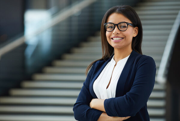 Product marketing manager standing in front of a stairway at corporate office