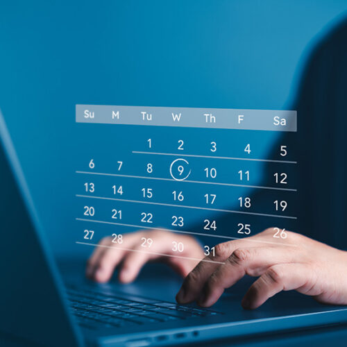 business man typing on computer with holograph of subscription calendar on top