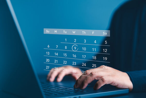 business man typing on computer with holograph of subscription calendar on top