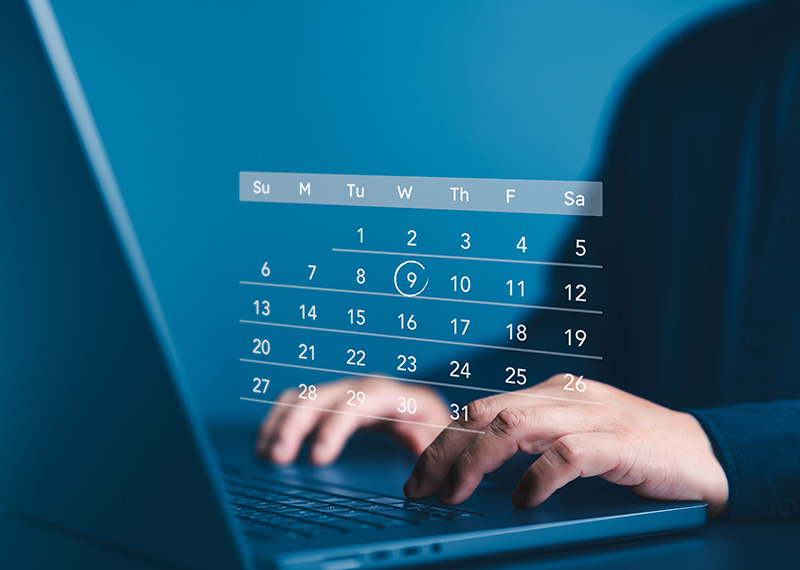 business man typing on computer with holograph of subscription calendar on top