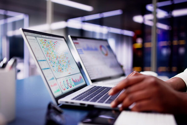 business woman with CRM system on laptop and office in background