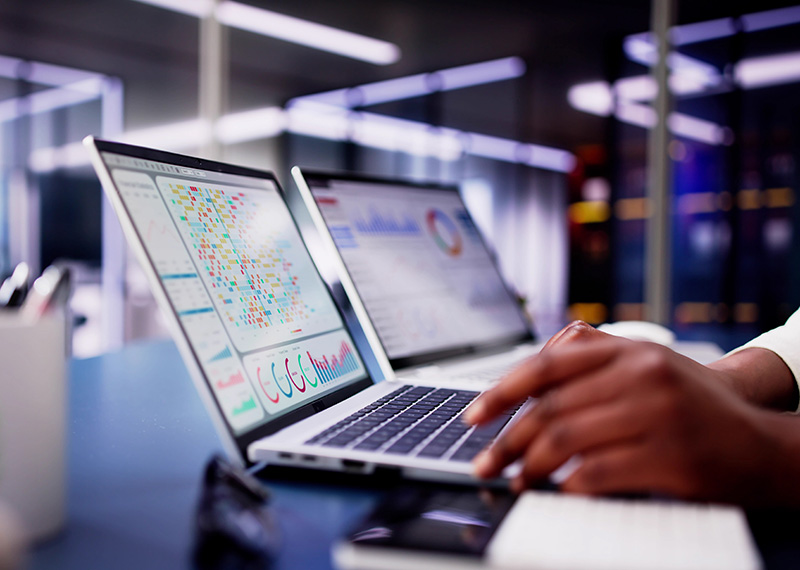 business woman with CRM system on laptop and office in background