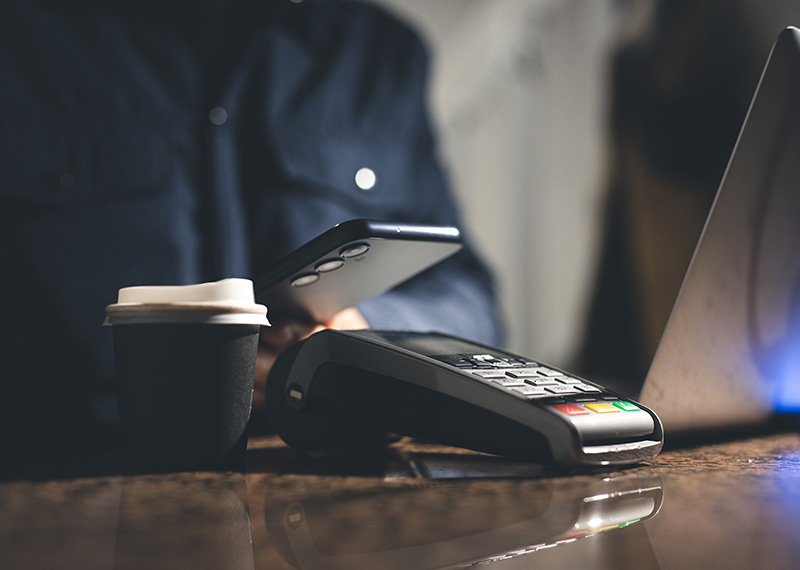 paying for coffee with smart phone digital wallet at point of sale