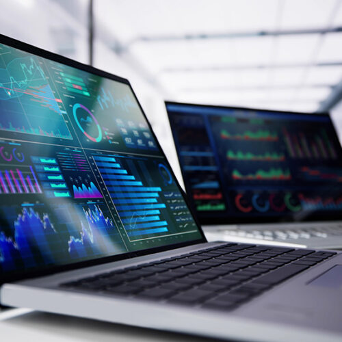 laptop with saas revenue forecasting model visible on screen and office in background