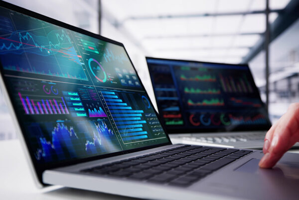 laptop with saas revenue forecasting model visible on screen and office in background