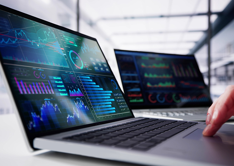 laptop with saas revenue forecasting model visible on screen and office in background