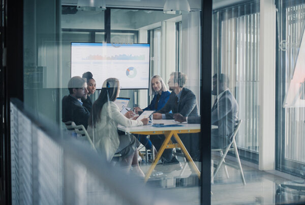 customer success team reviewing saas renewal pipeline in conference room of office building