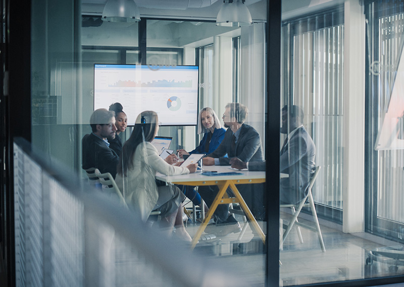customer success team reviewing saas renewal pipeline in conference room of office building