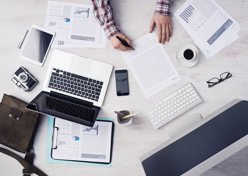 finance manager comparing subscription billing software to erp software at desk