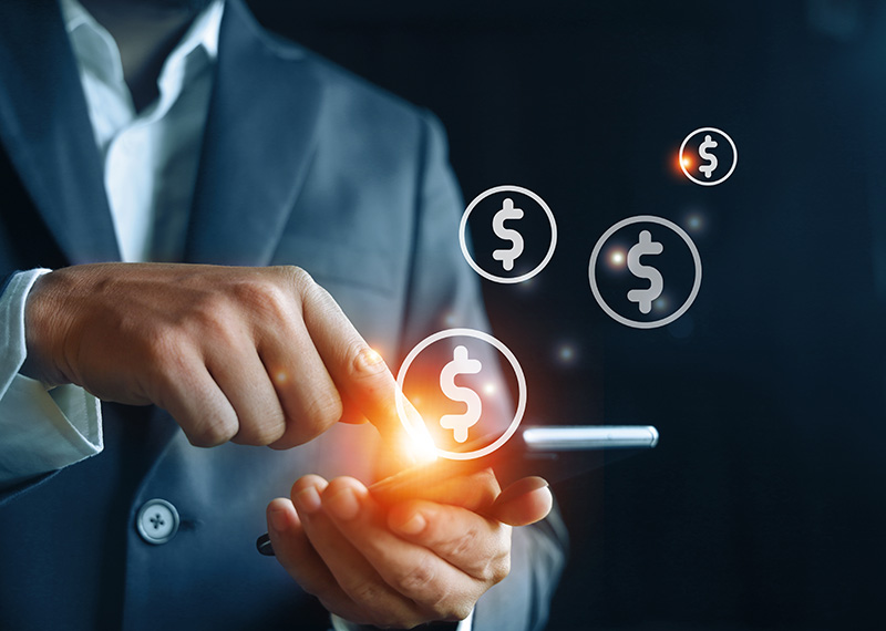 Business man holding smartphone with dollars signs above it