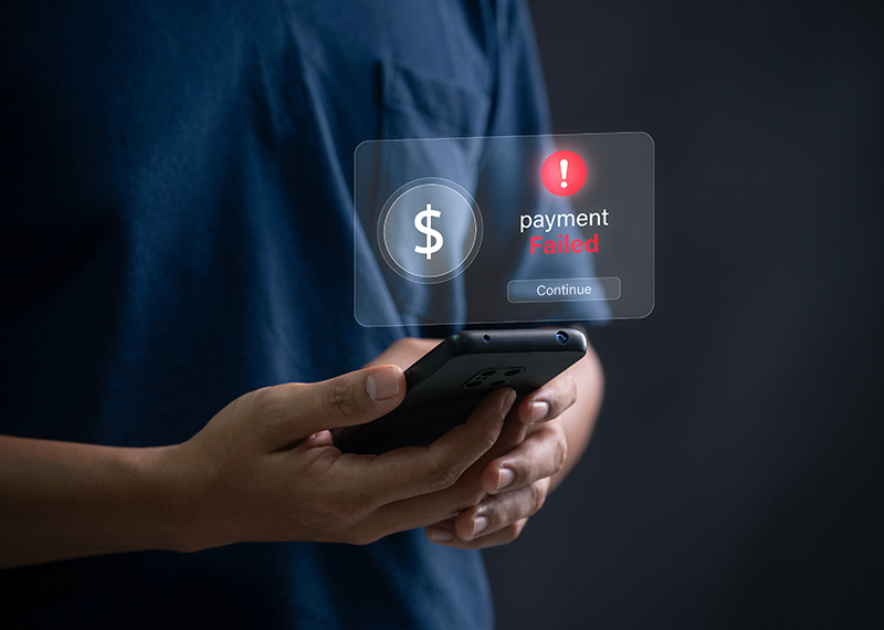 man holding smartphone viewing payment failure