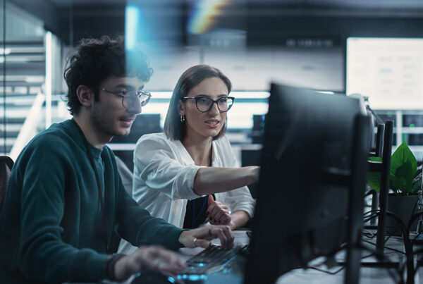 two developers coding saas entitlements into a business application