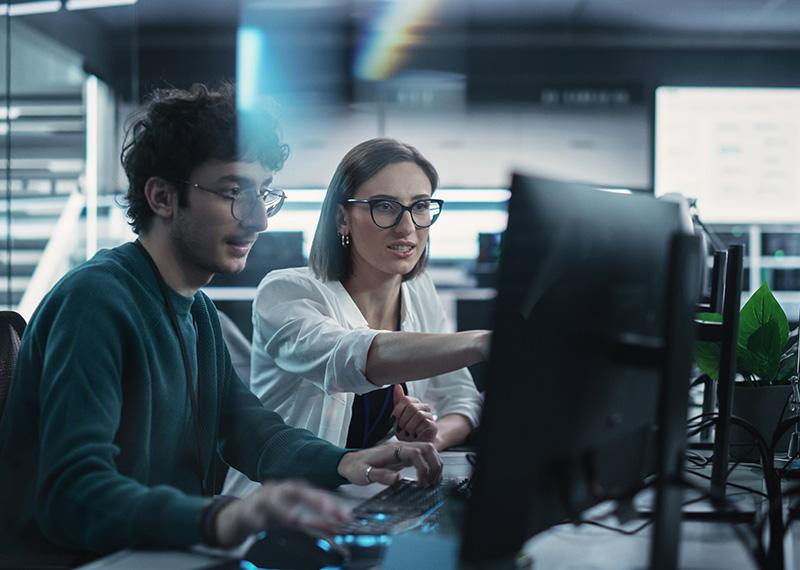 two developers coding saas entitlements into a business application